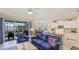Open concept living room and kitchen with sliding glass doors leading to the outdoor pool area at 3839 Autumn Fern Ter, Sarasota, FL 34243