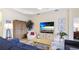Cozy living room features neutral colors, ceiling fan, and an entertainment center with a large TV at 3839 Autumn Fern Ter, Sarasota, FL 34243