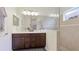 Bright bathroom featuring double sinks, a large mirror, and glass enclosed shower at 3839 Autumn Fern Ter, Sarasota, FL 34243