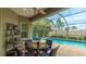 Enjoy the shade on this covered lanai area, overlooking the pool and lush landscaping at 3839 Autumn Fern Ter, Sarasota, FL 34243