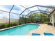 A screened pool featuring outdoor furniture and a brick patio within an enclosed backyard at 3839 Autumn Fern Ter, Sarasota, FL 34243