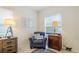 A sitting room features comfortable seating with a large window for natural light at 3839 Autumn Fern Ter, Sarasota, FL 34243