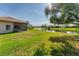 The backyard features a well-maintained lawn and scenic pond views, perfect for outdoor enjoyment at 4414 Turnberry Ct, Bradenton, FL 34210