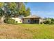 A spacious backyard showcasing a lush lawn and an enclosed lanai, backing up to a serene pond at 4414 Turnberry Ct, Bradenton, FL 34210