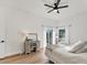 Cozy bedroom with light wood floors, ceiling fan, and natural light at 4414 Turnberry Ct, Bradenton, FL 34210