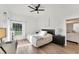 Inviting bedroom with light wood floors, fan, and generous natural light at 4414 Turnberry Ct, Bradenton, FL 34210