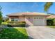 Charming single-story home featuring a tile roof, manicured lawn, and a two-car garage with a well-maintained driveway at 4414 Turnberry Ct, Bradenton, FL 34210