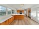 Bright, spacious kitchen features light-colored countertops, wood cabinetry, stainless steel appliances, and seamless flooring at 4414 Turnberry Ct, Bradenton, FL 34210
