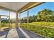 Screened-in lanai offers serene views of the lush yard and a tranquil pond, perfect for outdoor relaxation at 4414 Turnberry Ct, Bradenton, FL 34210