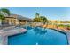 Large, well-maintained community pool with a sun deck, seating, and palm trees for a resort-style atmosphere at 4414 Turnberry Ct, Bradenton, FL 34210