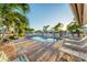 Inviting community pool surrounded by lush palm trees and lounge chairs for relaxing in the sun at 4414 Turnberry Ct, Bradenton, FL 34210