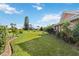 Landscaped backyard with lush green grass and tropical vegetation, creating a serene outdoor retreat at 534 Warwick Ln, Venice, FL 34293