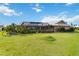 Expansive backyard features lush green grass and manicured landscaping for outdoor enjoyment at 534 Warwick Ln, Venice, FL 34293