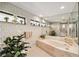 A serene bathroom showcases a soaking tub and tiled floors at 534 Warwick Ln, Venice, FL 34293