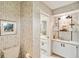 Bathroom features a display cabinet, toilet and wallpapered walls at 534 Warwick Ln, Venice, FL 34293