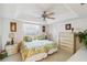 This bedroom with two twin beds features a ceiling fan and a window with blinds at 534 Warwick Ln, Venice, FL 34293