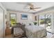 Bedroom with a crib and sliding doors to the outdoors at 534 Warwick Ln, Venice, FL 34293