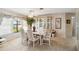 Well-lit dining room featuring tile floors, large windows, and a built-in china cabinet at 534 Warwick Ln, Venice, FL 34293