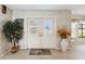 Welcoming entryway with double doors, elegant decor, and ample natural light at 534 Warwick Ln, Venice, FL 34293