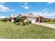 Charming single-story home featuring manicured landscaping, two-car garage, and a stylish roof at 534 Warwick Ln, Venice, FL 34293
