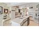 Bright kitchen featuring white cabinetry, modern appliances, and a large island with a dual sink at 534 Warwick Ln, Venice, FL 34293