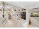 Open-concept kitchen featuring modern appliances, white cabinetry, and an island with breakfast bar seating at 534 Warwick Ln, Venice, FL 34293