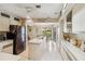 Bright kitchen featuring white cabinets, stainless appliances, and an island with a dual sink at 534 Warwick Ln, Venice, FL 34293