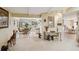 Open-concept living area connecting the dining room and kitchen, with tile flooring and ample natural light at 534 Warwick Ln, Venice, FL 34293