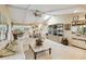 Spacious living room with high ceilings, modern furnishings, and seamless access to the dining area at 534 Warwick Ln, Venice, FL 34293