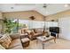 Cozy living room featuring a large window, vaulted ceiling, and comfortable seating at 534 Warwick Ln, Venice, FL 34293