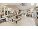 Spacious living room with high ceilings, modern furnishings, and seamless access to the dining area at 534 Warwick Ln, Venice, FL 34293