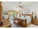 The main bedroom features stylish décor, a ceiling fan, and lanai access at 534 Warwick Ln, Venice, FL 34293