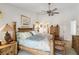 Charming bedroom with a decorative bamboo bed frame, ceiling fan, and furnishings at 534 Warwick Ln, Venice, FL 34293
