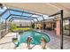 Beautiful screened-in pool and spa area with statues, perfect for relaxation and entertainment at 534 Warwick Ln, Venice, FL 34293