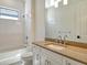 Bathroom features a white vanity, quartz countertops, and a tub with white subway tile at 552 Bocelli Dr, North Venice, FL 34275