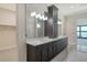 Bright bathroom with a double sink vanity, expansive mirror, and views of the waterfront at 552 Bocelli Dr, North Venice, FL 34275