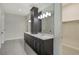 Bathroom with double vanity, dark wood cabinets, and a large mirror at 552 Bocelli Dr, North Venice, FL 34275