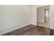 Empty bedroom with hardwood floors and an open doorway at 552 Bocelli Dr, North Venice, FL 34275