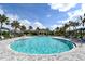 Stunning community pool featuring palm trees, lounge chairs, and cabanas at 552 Bocelli Dr, North Venice, FL 34275