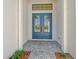 Stylish entryway with blue double doors and stone-paved walkway at 552 Bocelli Dr, North Venice, FL 34275