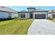 Beautiful home exterior with lush landscaping and a paver driveway at 552 Bocelli Dr, North Venice, FL 34275