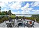 Outdoor fire pit area with seating, offering a serene spot to relax and enjoy the beautiful lakefront scenery at 552 Bocelli Dr, North Venice, FL 34275
