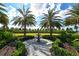 Beautiful tiered fountain surrounded by lush tropical landscaping, enhancing the community's serene ambiance at 552 Bocelli Dr, North Venice, FL 34275