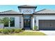 Elegant home featuring double door entry and a two-car garage with stone driveway at 552 Bocelli Dr, North Venice, FL 34275