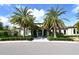 Elegant home exterior with palm trees and landscaped circular driveway at 552 Bocelli Dr, North Venice, FL 34275