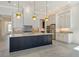 Modern kitchen with an island, stainless steel appliances, and pendant lighting at 552 Bocelli Dr, North Venice, FL 34275