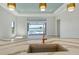 A kitchen boasts an island sink and open floor plan leading to the pool and water views at 552 Bocelli Dr, North Venice, FL 34275