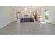 Open-concept kitchen features an island, stainless steel appliances, a tiled backsplash, and pendant lighting at 552 Bocelli Dr, North Venice, FL 34275