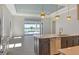 A modern kitchen leads to an open floor plan and views of the pool at 552 Bocelli Dr, North Venice, FL 34275