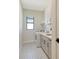 Bright laundry room with a washer and dryer, utility sink, and patterned flooring at 552 Bocelli Dr, North Venice, FL 34275